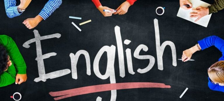 english written on a banner student are sitting around a table