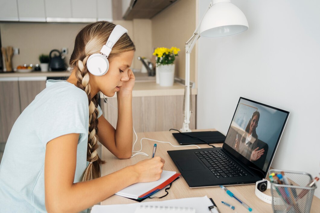 young girl paying attention to online tutoring class