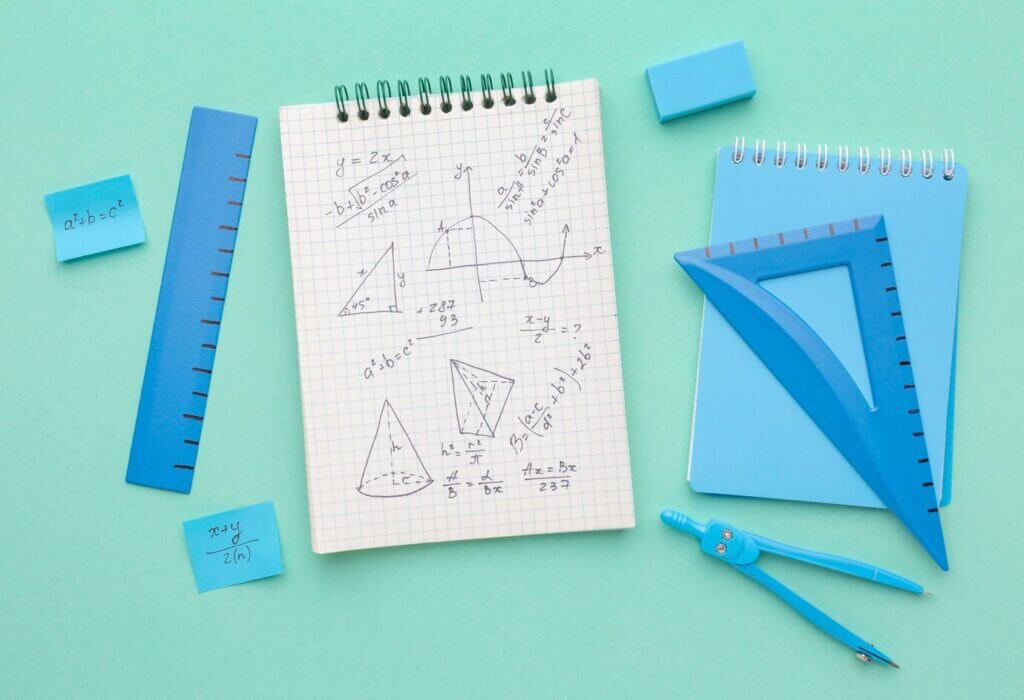 1. A vibrant green background showcases a blue notebook, pencils, a ruler, and various school supplies, perfect for back-to-school vibes.