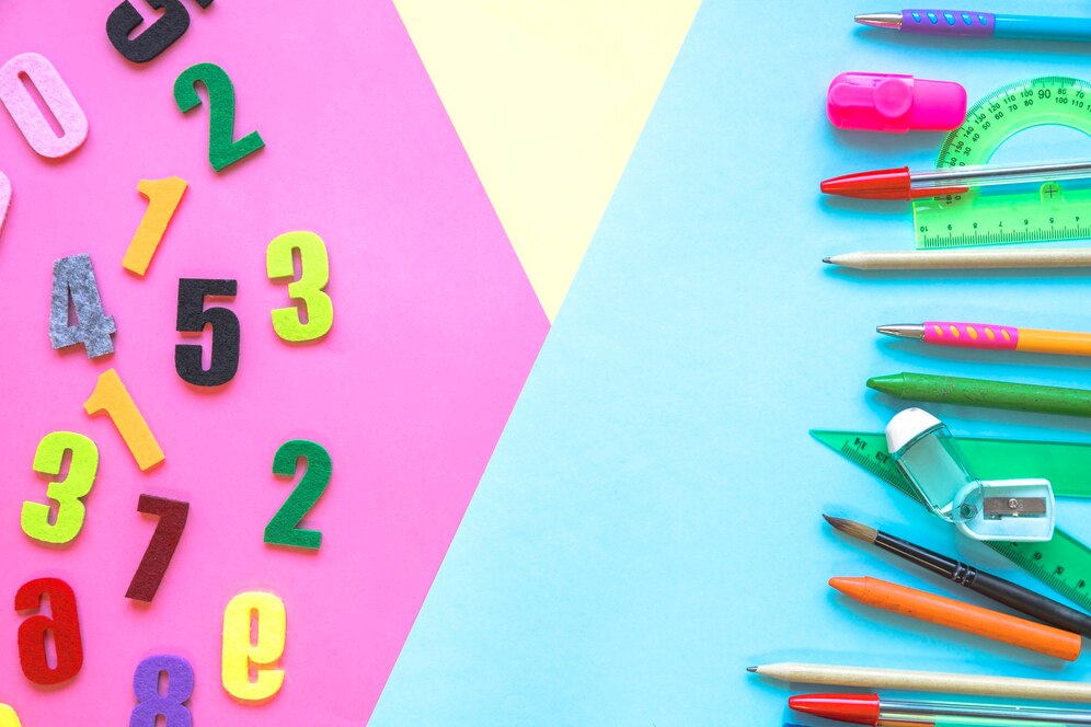 Colorful school supplies and felt numbers on a pink and blue background.