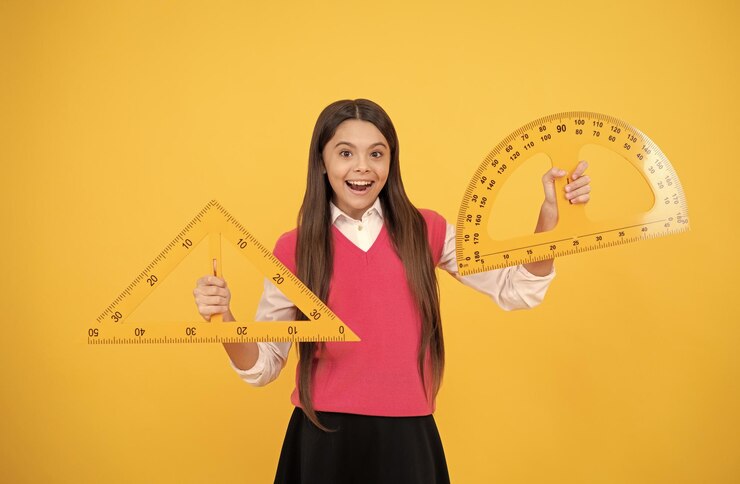 A person holds a yellow triangular ruler in one hand and a curved protractor in the other, set against a vibrant yellow background.