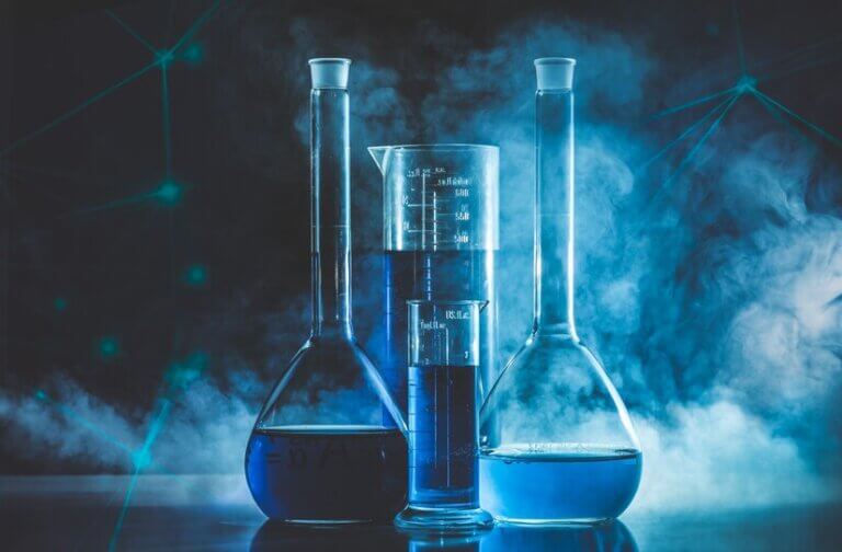 Several beakers filled with colorful liquids arranged on a table, showcasing the transparent material and typical laboratory setup.