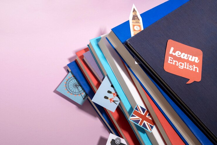 A stack of colorful English learning books topped with a speech bubble reading "Learn English" and various travel-themed icons.