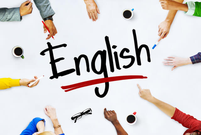 A group of diverse hands surround the word "English" written in bold, with coffee cups and glasses scattered on the table.