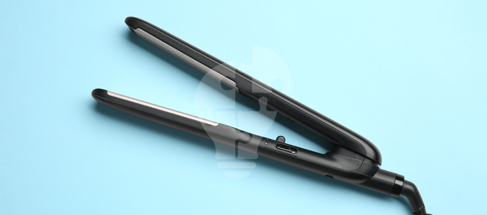 A sleek black hair straightener with a digital display rests open on a light blue background. Its modern design gives a sense of elegance and simplicity.