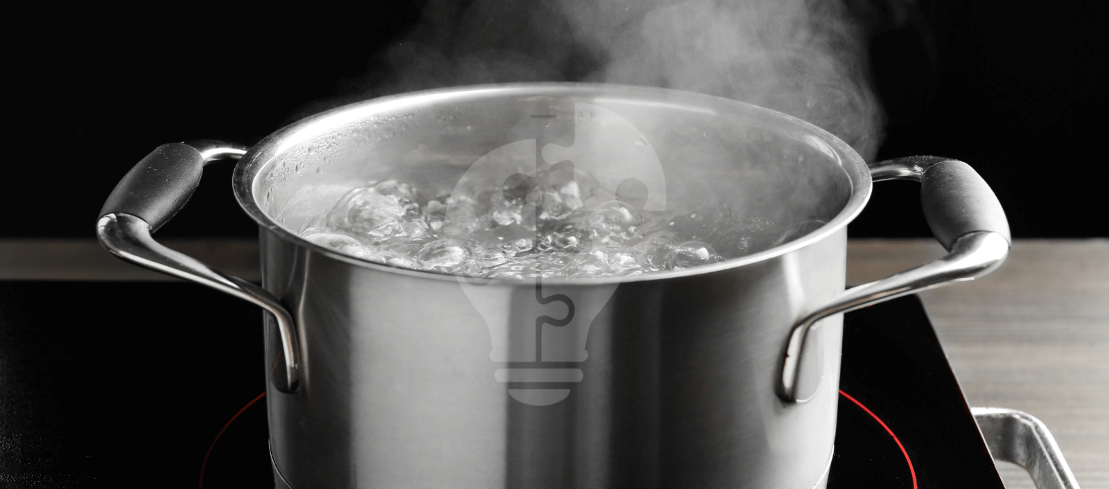 A stainless steel pot of water boils vigorously on an electric stove, steam rising into the air against a dark background, suggesting a sense of warmth and activity.